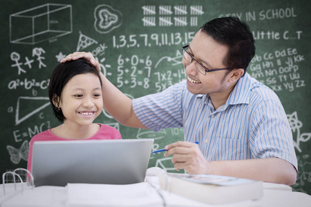 亚洲可爱女学生在课堂上被老师表扬的肖像照片