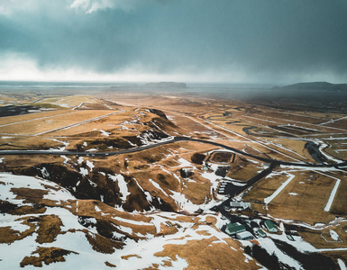 冰岛鸟瞰风景与雪和云彩, 街道和黄色和绿色草