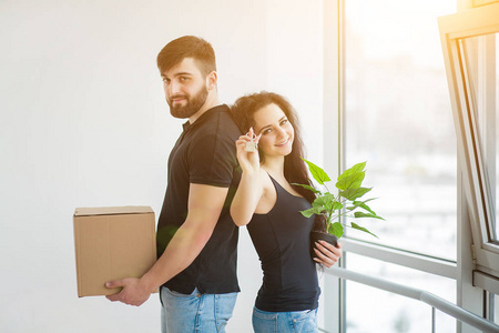 年轻夫妇在新家拆箱纸箱。搬家房