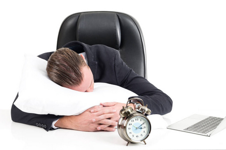 年轻的商业男子拥抱和睡眠在枕头上孤立的白色背景