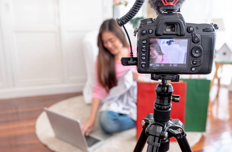 亚洲年轻女性博客录制沃客视频与审查布 t恤衫在家里在线影响社会媒体的概念. 实时流病毒