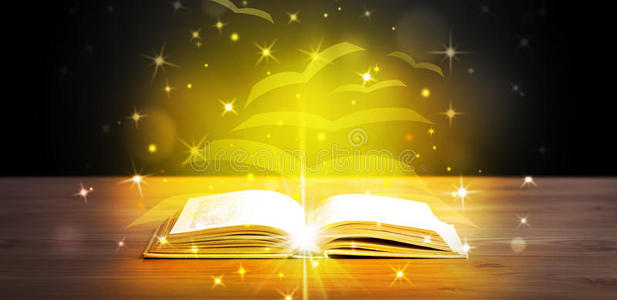 翻开金色发光纸页的书照片