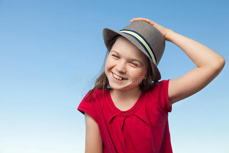 外面穿红衬衫戴帽子的可爱小女孩