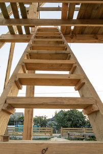 在日落时, 一座木框架房屋的屋顶的楼梯。在乌克兰建造一座框架房屋