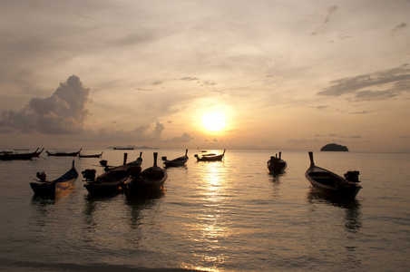 模糊的轮廓传统长尾船海上夕阳光