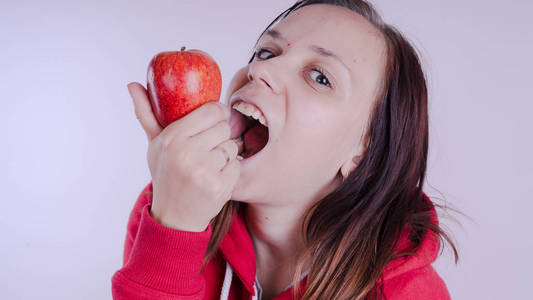 雌性手在白色背景下保存红色水果, 特写。女孩的脸抱着新鲜的苹果。园艺和秋季概念。妇女提供本土收获
