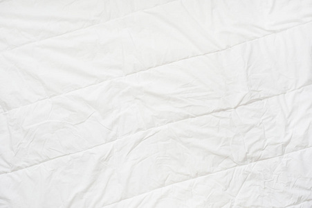白色的被子皱巴巴的被子白色毛毯纹理.特写照片