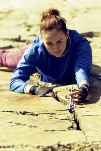 女子攀岩爬上悬崖。攀岩者爬上