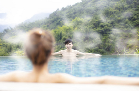 年轻的亚洲情侣在温泉放松