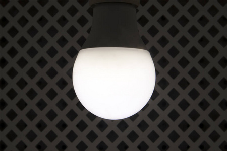 现代圆形节能灯泡对 rhombed 格子背景的保护