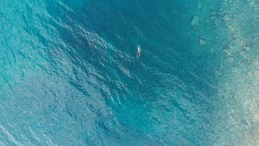 空中 一人潜水员游泳捕鱼在水晶清澈的地中海, 深蓝色透明的水, 夏季体育假期概念