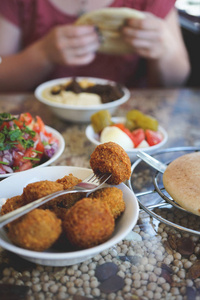 有以色列午餐的女孩们。Falafels, 鹰嘴豆泥, 配沙拉和皮塔饼。耶路撒冷以色列