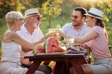 快乐的大家庭在夏日花园聚会上吃午饭.人, 食物, 爱和幸福概念照片