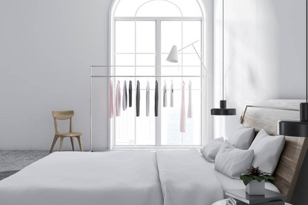 斯堪的纳维亚风格的卧室, 白色的墙壁, 瓷砖地板, 衣架, 和床头桌的主床。侧面视图3d 渲染模拟