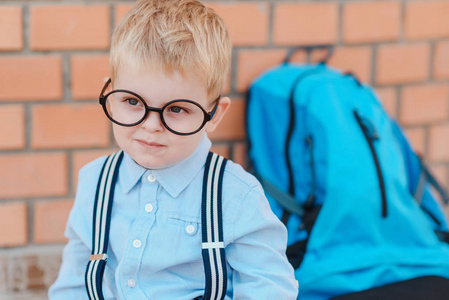 快乐聪明的戴眼镜的孩子第一次去上学。带书包的小孩去上小学。小学儿童