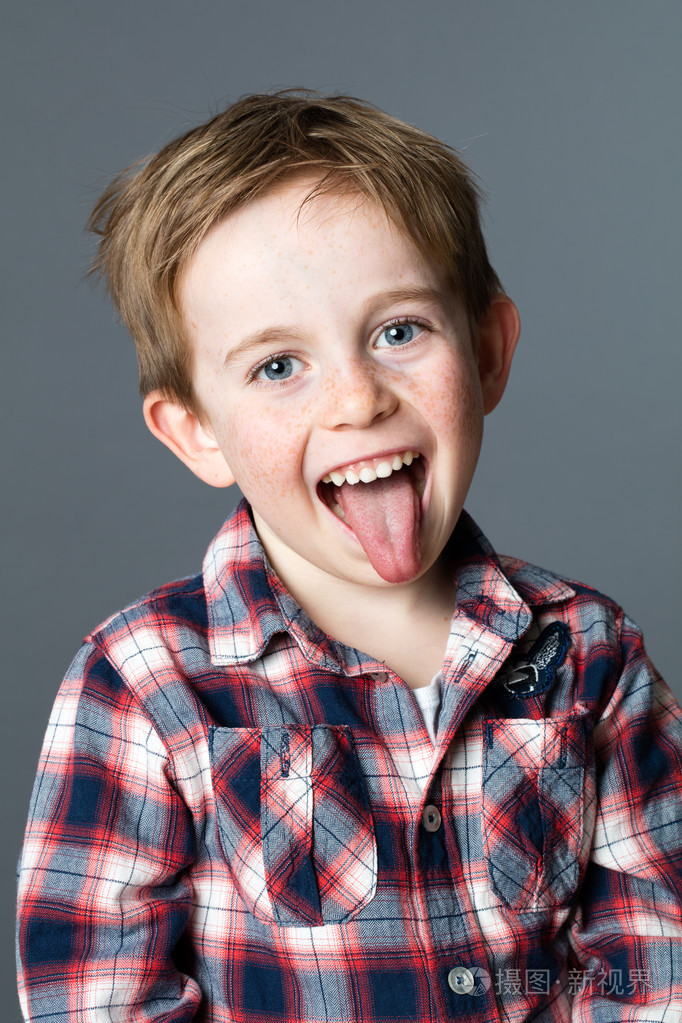 微笑的年轻男孩,伸出他的舌头在开心