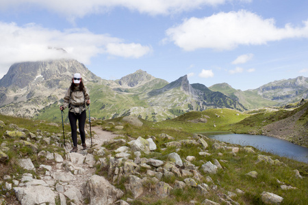 徒步旅行者女人之间石头山和湖徒步旅行