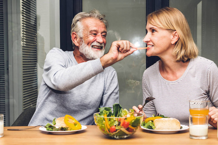高级夫妇喜欢在厨房里一起吃健康的早餐。退休夫妇概念