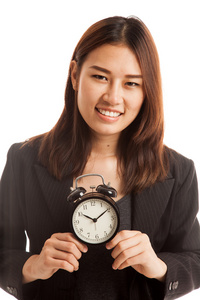 年轻的亚洲业务的女人微笑与时钟
