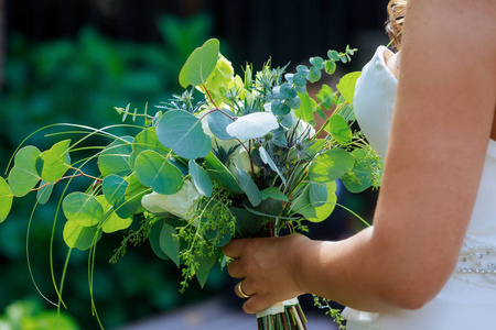 新娘在白色礼服握在他的手新娘花束玫瑰花, 婚礼