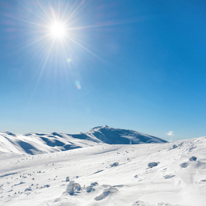 白色的冬天山与雪和明媚的阳光和太阳的光辉