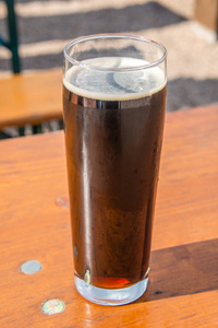 传统 Octoberfest 巴法力亚黑啤酒在一个大玻璃与湿墙壁, 德国, 室外