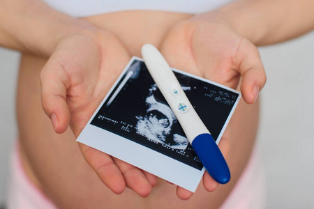 超声图像和阳性妊娠试验在怀孕女孩手中
