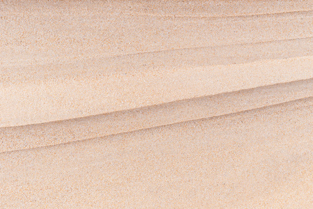 在海滩上的抽象明亮砂纹理