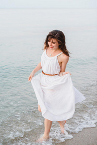 一个快乐微笑的女孩在海边奔跑图片