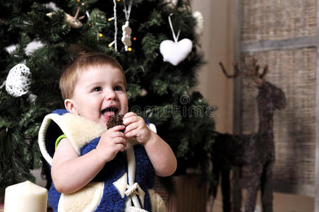 可爱的宝宝抱着圆锥形的圣诞树