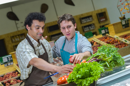 在超市商店工作的两个杂货店售货员的肖像照片