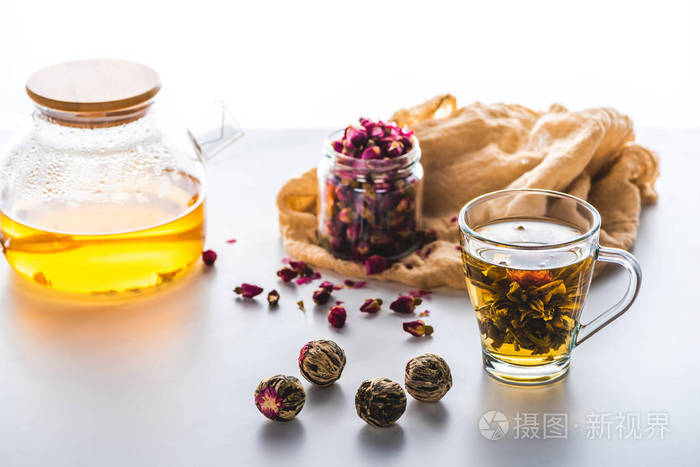 玫瑰花蕾在罐子里 一杯中国花茶 茶球放在白色桌面上照片 正版商用图片0sl3z1 摄图新视界 玫瑰花蕾在罐子里 一杯中国花茶 茶球放在白色桌面上照片 正版商用图片0sl3z1 摄图新视界