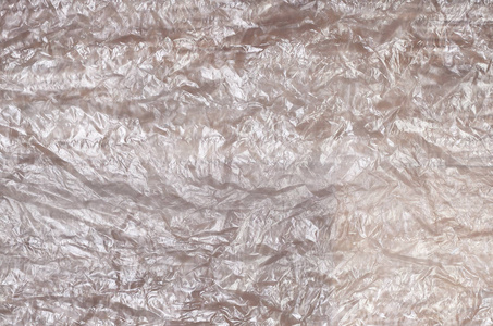 白色皱着的玻璃纸表面的质地在阳光下透明.