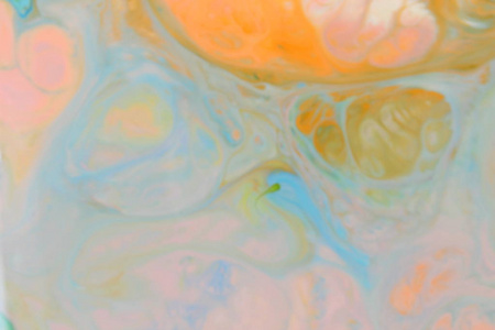 流体艺术。抽象橙色绿色背景在液体。多彩多姿的油漆污渍。设计器的模糊模式。当代艺术