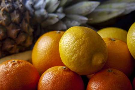 菠萝与热带水果混合, 包括橙色, 柠檬和柑橘在黑色背景下隔离