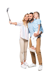 微笑的家庭采取自拍在智能手机上孤立的白色