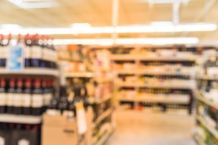 模糊图像的葡萄酒货架上的价格标签陈列在美国德克萨斯州休斯顿。弥散在超市货架上排上了酒瓶。酒精饮料文摘背景