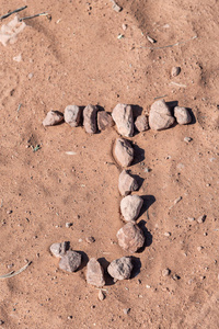 J 在海滩上签名用小石头写。度假理念