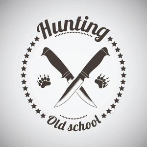 交叉的刀和熊的足迹.深褐色复古风格.矢量插图照片