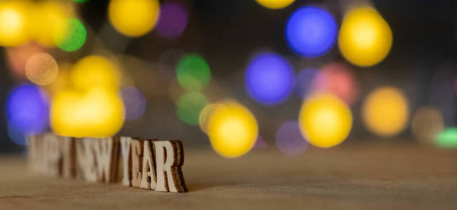 新年快乐木字散景背景灯。选择性聚焦