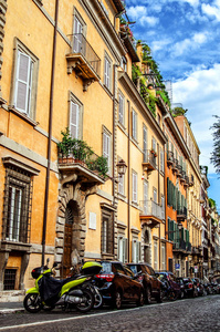 罗马街与美丽的有色房子。许多汽车停在路边的房子下面。
