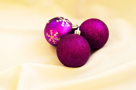 圣诞节的时候。在白色织物上的紫色圣诞球。