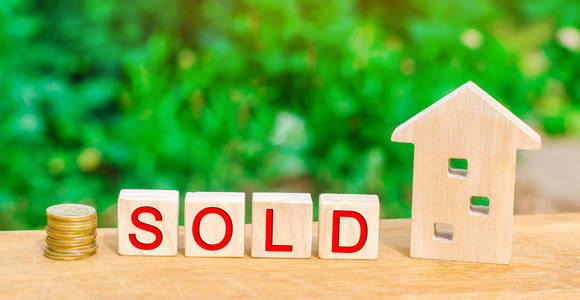 木房子和硬币以题字 卖了。房地产, 房屋, 不动产的出售。经济适用房