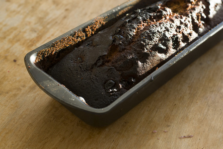 煮得时间过长在木桌上烧焦的姜饼上照片