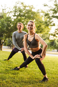 强健身运动的形象在公园户外的情侣朋友做伸展运动
