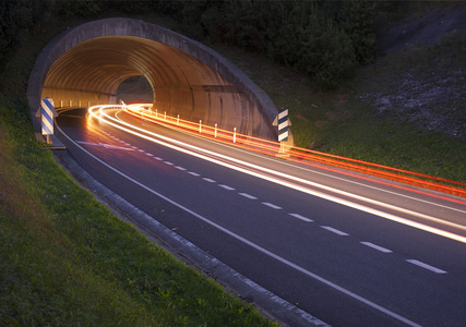 夜间行车。隧道的道路上车辆灯光