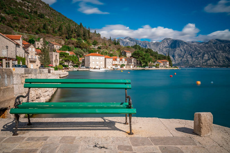 在黑山 Kotor 湾美丽的 Perast 镇的海滨空板凳上