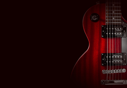 红色的电吉他，在黑色背景上的一部分。写入的文本的地方