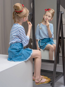镜子旁的小女孩画口红唇