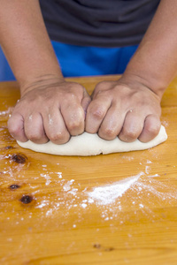 厨师准备面团在厨房桌子用手, 特写